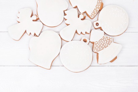 White glazed Christmas cookies on white wooden background. Top view. Flat layの写真素材