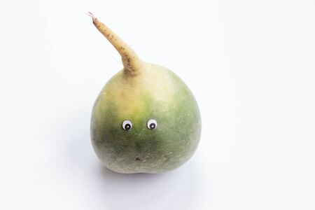 Green radish with cartoon eyes on white background. Funny food conceptの写真素材