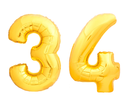 Golden number 34 thirty four of inflatable balloon isolated on white backgroundの写真素材