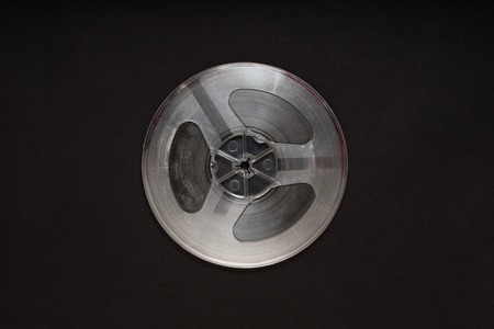 Spinning reel of old tape recorder on black backgroundの写真素材