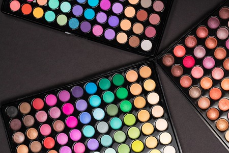 Make-up palettes on black background. Top viewの写真素材