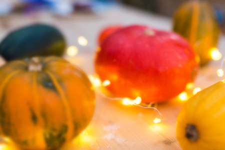 Blurred background colorful pumpkins on a table with lights