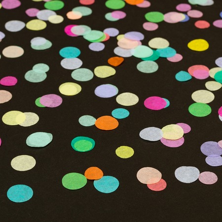 Close-up of confetti on black backgroundの写真素材