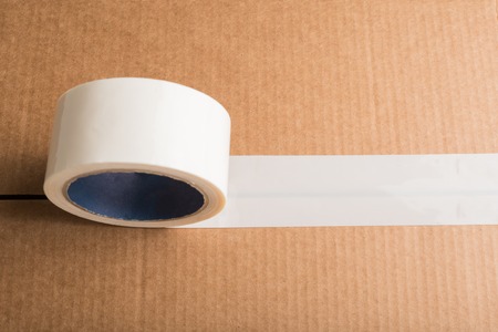 Cardboard box with white adhesive tape with copyspace. Top viewの写真素材