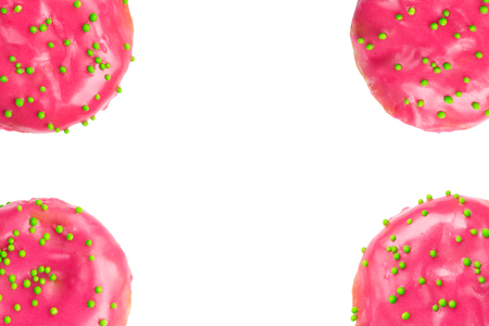 Pink glazed donuts frame isolated on white background. Flat lay. Top viewの写真素材