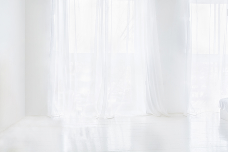 Empty white room with curtains on windows. Abstract interiorの写真素材