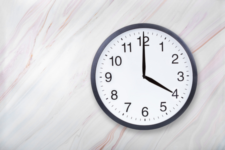 Wall clock show four oclock on marble texture. Office clock show 4pm or 4am on marble texture with natural patternの写真素材
