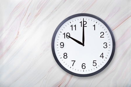 Wall clock show ten oclock on marble texture. Office clock show 10pm or 10am on marble texture with natural patternの写真素材