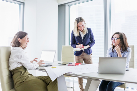 Group of happy business women having fun at work. Fun at office conceptの写真素材