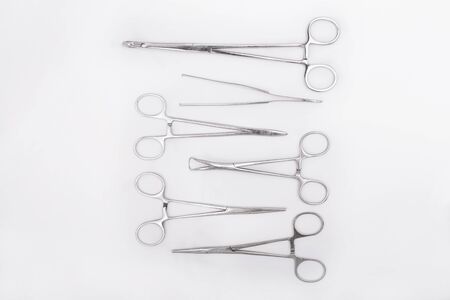 Metal surgical instruments on white background. Flat lay. Top viewの写真素材