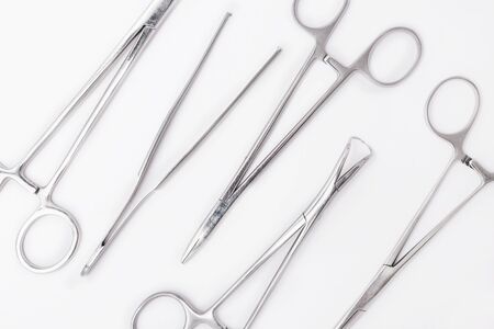 Plastic surgical tools background. Metal surgical instruments on white backgroundの写真素材