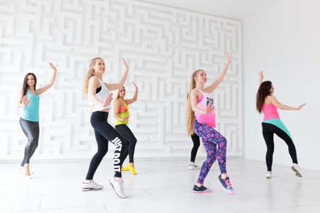 RUSSIA, MOSCOW, 2017 - MARCH 12: Group of young happy women wearing colorful sportswear dancing at Zumba classのeditorial素材