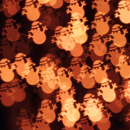 Abstract defocused bokeh background with group of abstract Christmas snowmen