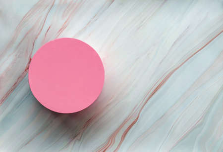Minimal marble background with pink round box. Round gift box on marble texture with space for your copy. Flat lay. Top viewの写真素材