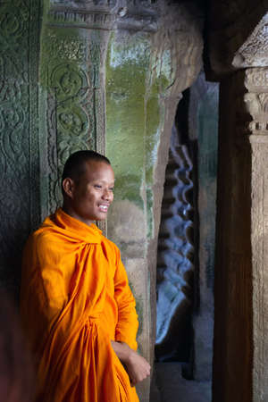 SIEM REAP, CAMBODIA - APRIL 5, 2012: Portrait of young monk in orange robe in the Angkor Wat ancient templeのeditorial素材