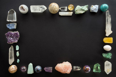 Frame made of crystal stones on black background. Colorful gemstones and crystals on dark background with copy space.の写真素材