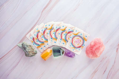 Crystals and gemstones with Tarot cards on a marble table backgroundのeditorial素材