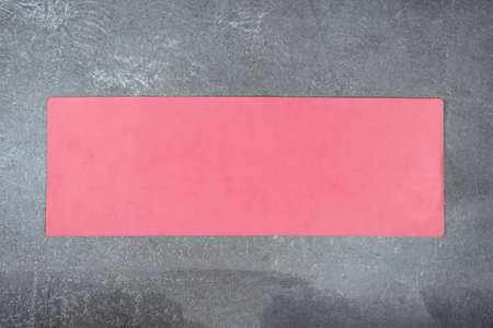 Pink yoga mat on concrete floor. Fitness mat is spread out on cement floorの写真素材
