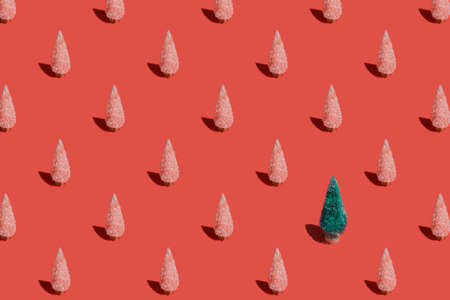 Christmas pattern background of Christmas trees on red texture. Minimal New Year conceptの写真素材
