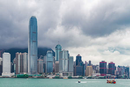 Skyscrapers of the Victoria Harbour in Hong Kong against cloudy sky