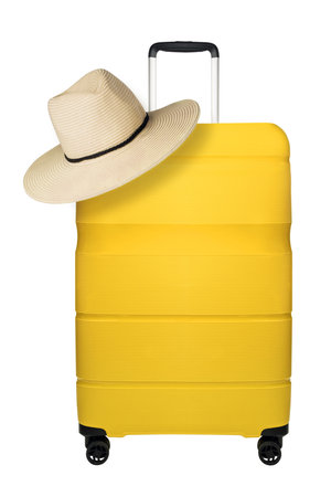 Travel yellow suitcase with straw hat isolated on white backgroundの写真素材