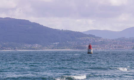 seascape with a lighthouse and mountains