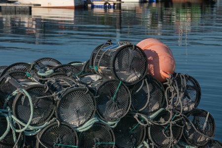 Fishing shrimp traps stacked on the pier close up view with sunlightの写真素材