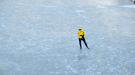 Ice skating on the frozen lake. Winter sports. Ice hockey.の写真素材