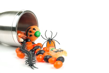 Halloween Cup spilling candy isolated on a white backgroundの写真素材