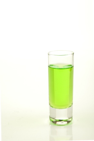 Green shot of absinth isolated on a white backgroundの写真素材