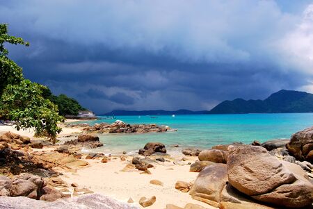 Beautiful beach surrounded by islands before tropical rainの写真素材
