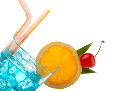 Blue hawaiian curacao cold cocktail decorated with orange,  pineappleand and cherry, filled with ice isolated on a white backgroundの写真素材