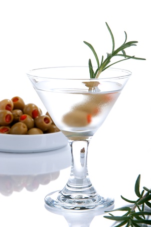 Classic Martini with olives filled by red papper inside and rosmarin isolated on a white backgroundの写真素材