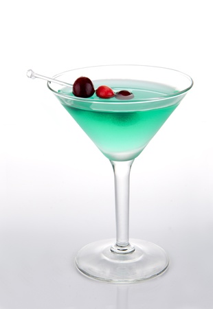 Green Martini bikini cocktail decorated with cranberries isolated on a white backgroundの写真素材