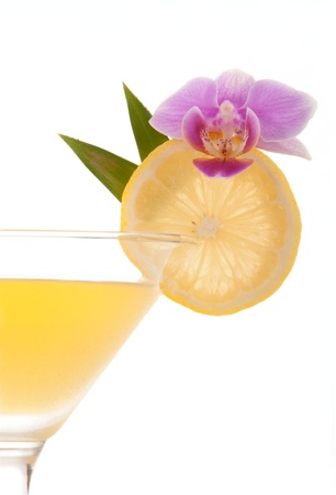 Jolly Rancher Martini with raspberry vodka, sour apple liqueur, raspberry liqueur, banana liqueur, red cranberry juice decorated with lemon wheel and orchid isolated on a white backgroundの写真素材