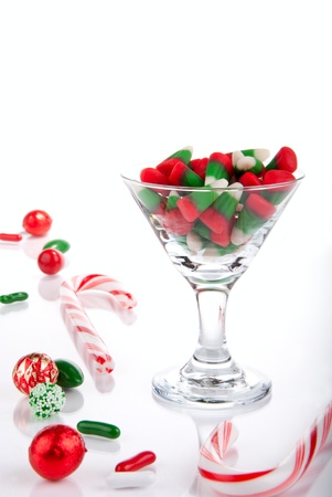 Christmas candies, canes and candy-corn in martini glass isolated on a white backgroundの写真素材