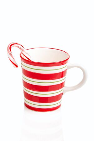 Red striped Christmas cup with candy cane isolated ona white backgroundの写真素材