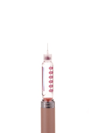 Insulin syringe pen with 10mm needle and insulin flask inside isolated on a white backgroundの写真素材