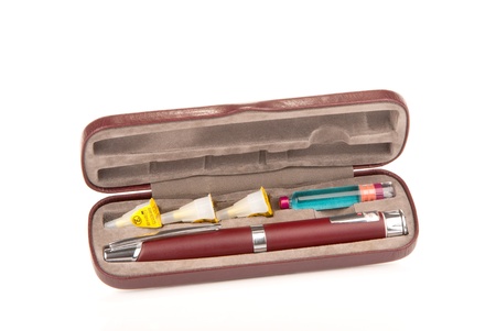 Insulin syringe injection pen in the case with extra insulin flask and three needles inside isolated on a white backgroundの写真素材
