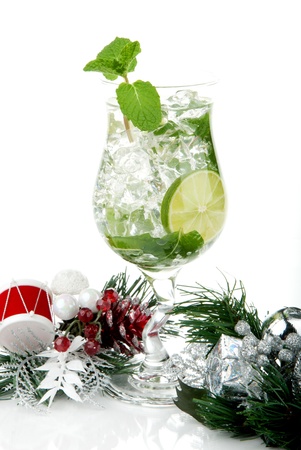 Classic Mojito cocktail with christmas ornament, mint leaves, lime, sirup, light bacardi rum, sprite soda and  isolated on a white backgroundの写真素材