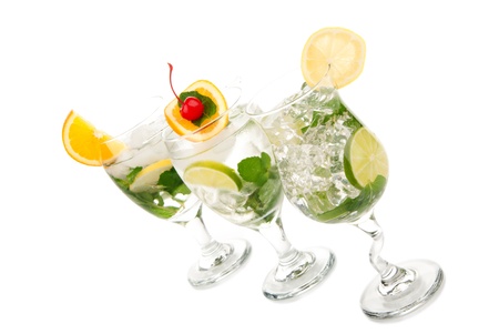 Tropical summer Mojito cocktail with mint leaves, lime, simple syrup, light bacardi rum, club soda, tequila, orange slice and maraschino cherry isolated on a white backgroundの写真素材