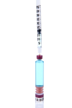 Medic filling the syringe with an insulin vaccine from flask isolated on a white backgroundの写真素材