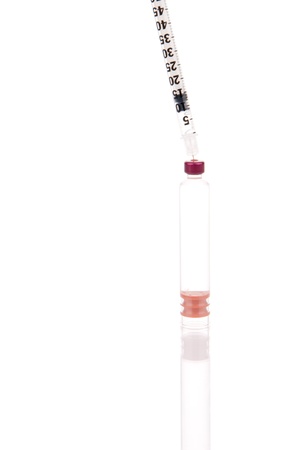 Insulin syringe with full flask ready for injection isolated on a white backgroundの写真素材