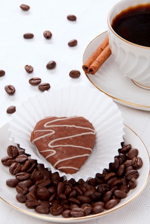 Cup of hot espresso coffee with chocolate almond cookie and beans isolated on a white backgroundの写真素材