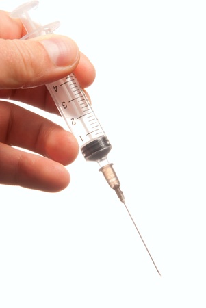 Professional doctor hand with medical syringe and needle getting ready for injection in hospital isolated on a white backgroundの写真素材