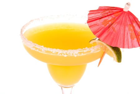 Orange and Apple margarita in chilled salt rimmed glass with tequila, triple sec, juice, simple syrup and crushed ice garnished wedge of fresh lime and umbrella. Most popular cocktail.の写真素材