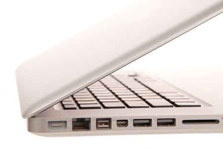 Side view of modern laptop computer with usb, MagSafe power, Gigabit Ethernet port, One FireWire 800, SD card slot isolated on whiteの写真素材