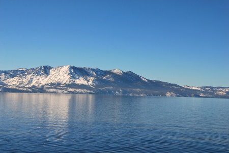 Beautiful snow capped mountains and Lake against the blue sky の写真素材