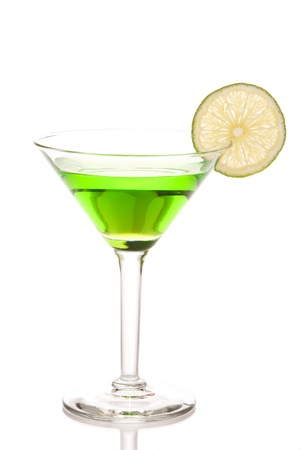Green matrini cocktail with lime wheel, vodka, pineapple juice, liqueur in classic martiny cocktail glass isolated on white backgroundの写真素材