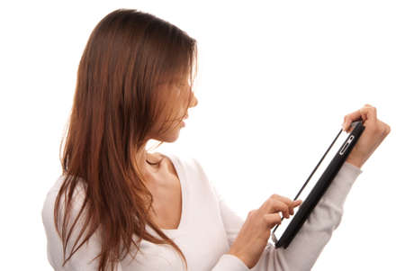 Brunette woman typing on her new electronic tablet touch pad computer pc one finger touches the digital screen isolated on a white backgroundの写真素材